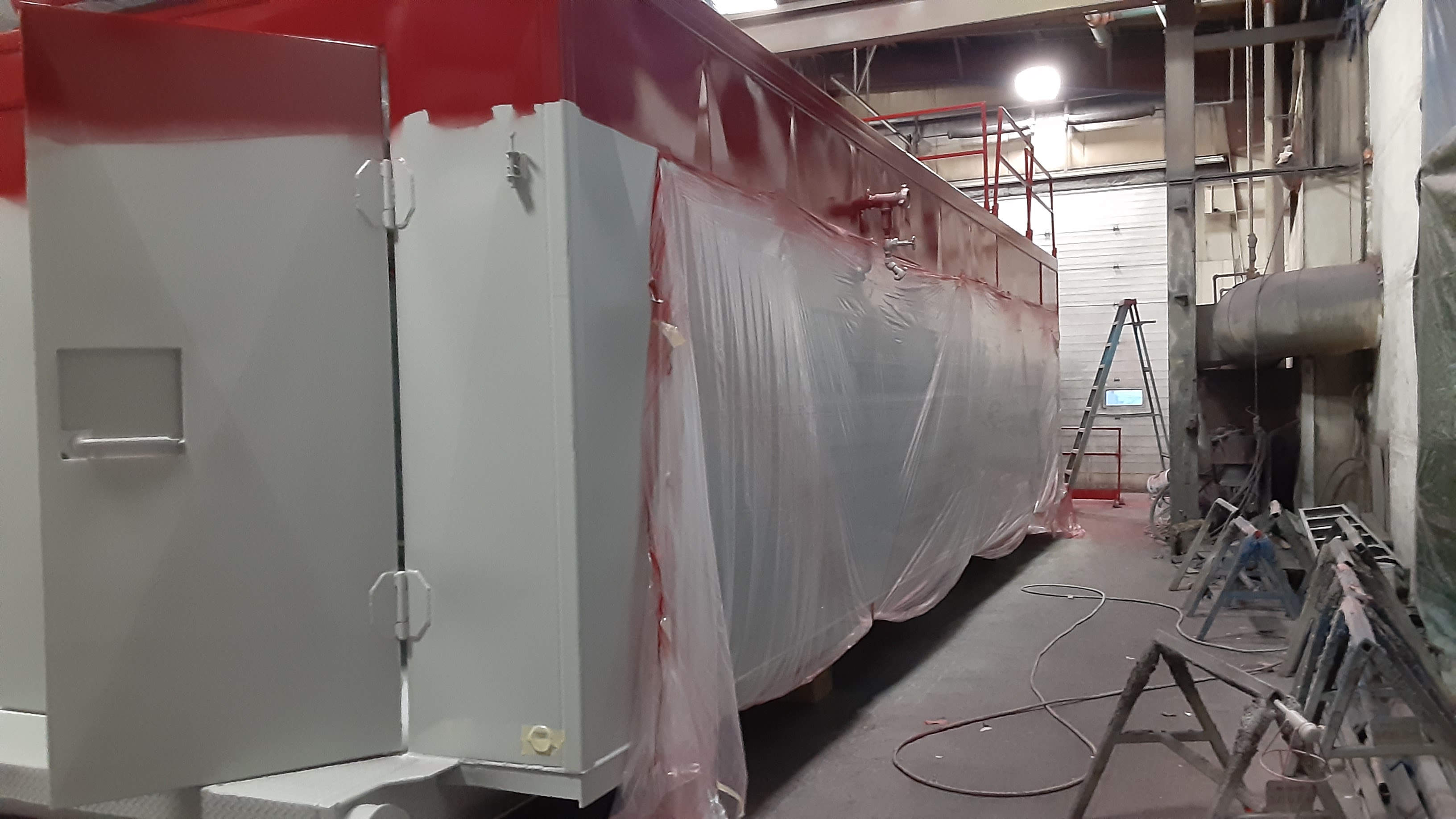 A boiler being prepped for the next coat of paint